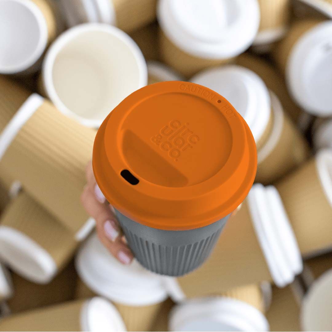 circular&co logo visible on top of returnable cup orange lid appearing from single use cups